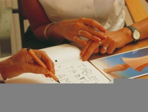 Therapist teaching stroke patient to write