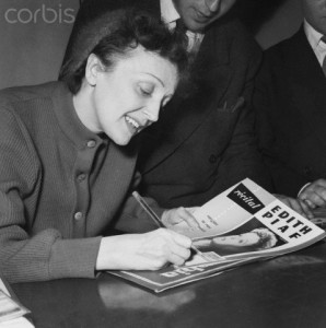 Edith Piaf Autographs a Magazine at the Olympia