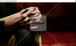 Argentine musician Charly Garcia crosses his fingers over his legs during an interview with Reuters ahead of his concert at Teatro Colon opera house in Buenos Aires