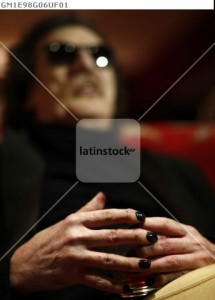 Argentine musician Charly Garcia holds a glass as he speaks during an interview with Reuters ahead of his concert at Teatro Colon opera house in Buenos Aires