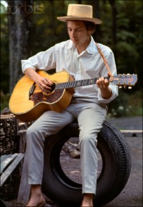 Bob Dylan Sitting on a Tire Playing Guitar