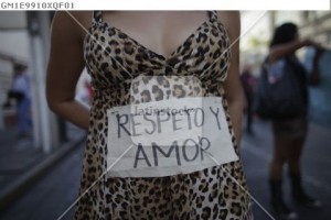 A woman shows a sign taped to her body during the "March of the Whores" to protest against discrimination and violence against women in Monterrey