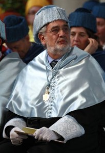 Spanish tenor Placido Domingo sits after receiving a degree honoris causa from the Alfonso X El Sabio University near Madrid