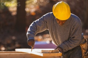 Carpenter marking bevel cuts on rafter