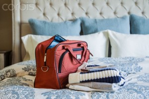 Bag and sweater on bed