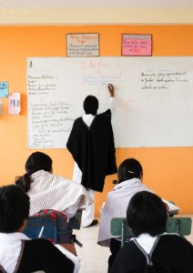 School children (6-7) and male teacher wearing traditional Ecuadorian costume, Ecuador
