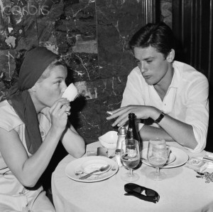 Romy Schneider and Alain Delon Sitting at Table