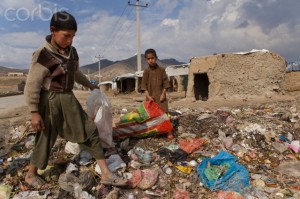 Children earning income collecting plastic and recyclables in trash