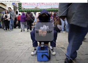 Boy working as a shoe shiner is seen in La Paz