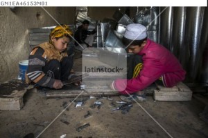 Children work at metal suitcases workshop in Mazar-I-Sharif