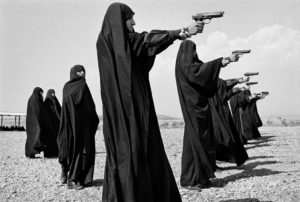 IRAN. Tehran. 1986. Veiled women practice shooting on the outskirts of the city.