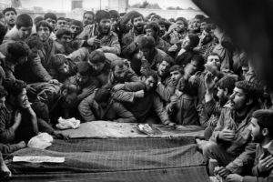 IRAN. City of Qum. 1986. Mourners around the coffy of FAZOLLAH MAHALLITI, and the other 12 victims of a recent plane crash. The plane was shot down by Iraqi aircraft during the war between the two countries.
