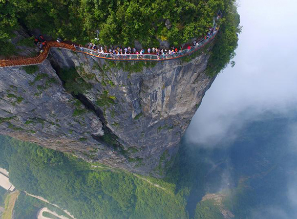 People walk on a sightseeing platform in Zhangjiajie, Hunan Province, China, August 1, 2016. REUTERS/Stringer ATTENTION EDITORS - THIS IMAGE WAS PROVIDED BY A THIRD PARTY. EDITORIAL USE ONLY. CHINA OUT. NO COMMERCIAL OR EDITORIAL SALES IN CHINA. TPX IMAGES OF THE DAY