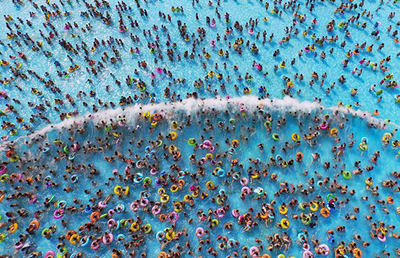 People cool off at a water park, in Nanjing, Jiangsu province, August 1, 2015. Temperature hit 35 degrees Celsius (95 degrees Fahrenheit) in Nanjing on Saturday. Picture taken August 1, 2015. REUTERS/China Daily CHINA OUT. NO COMMERCIAL OR EDITORIAL SALES IN CHINA TPX IMAGES OF THE DAY