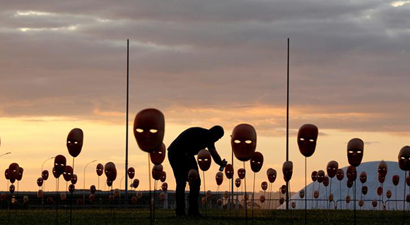 A man paints masks during a protest by non-governmental organization (NGO) Rio de Paz (Rio of Peace) against political corruption scandals, in front of the National Congress in Brasilia, Brazil May 23, 2017. REUTERS/Paulo Whitaker TPX IMAGES OF THE DAY