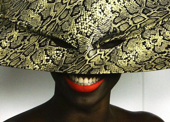 A guest wearing a hat mask arrives for the 'Bal Masque' party in honour of British fashion photographer Nick Knight at Strawberry Hill House in London. Photo by Kieran Doherty