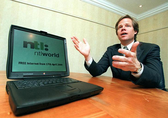 Chief Executive of communications company NTL, Barclay Knapp poses with a laptop computer advertising the launch date of NTL's free internet access, March 7. NTL is offering its telephone customers unlimited access to the internet via home computers from April 17. HP