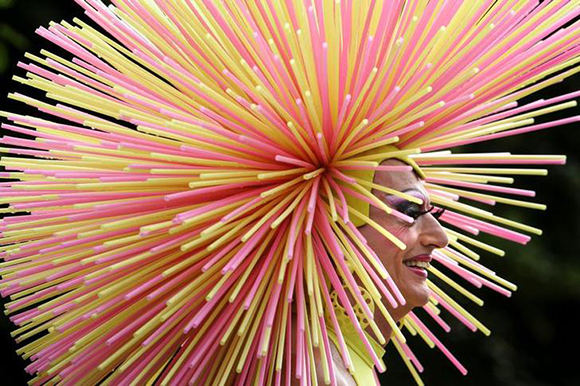 A participant with a fancy hat enjoys the Christopher Street Day festival in Berlin in Berlin. Photo by Christian Charisius