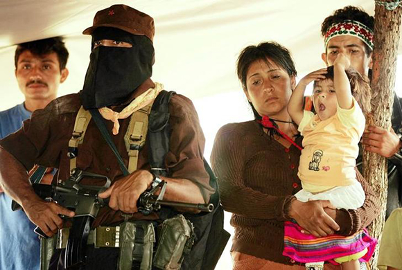 Member of Zapatista National Liberation Army stands guard during meeting between Zapatista leader Subcommander Marcos and indigenous organizations in Javier Hernandez. Photo by Daniel Aguilar