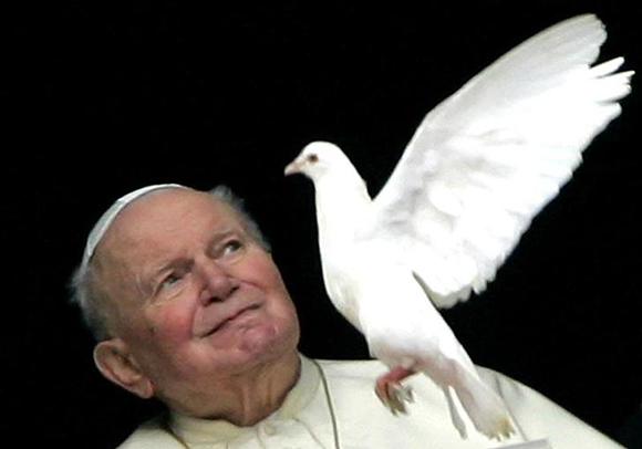 Pope John Paul II looks at a one of the two doves released by children from the window of his private apartments at the Vatican. Photo by Max Rossi