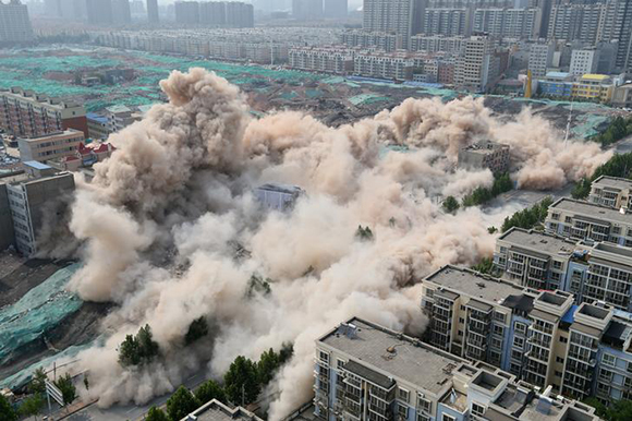 Buildings crumble during a controlled demolition for the reconstruction of urban villages in Zhengzhou, Henan province, China June 12, 2017. Picture taken June 12, 2017. REUTERS/Stringer ATTENTION EDITORS - THIS IMAGE WAS PROVIDED BY A THIRD PARTY. CHINA OUT. TPX IMAGES OF THE DAY