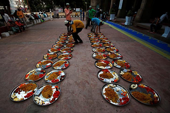 Men arrange Iftar (breaking fast) meals inside a mosque during the holy fasting month of Ramadan, in Ahmedabad, India June 14, 2017. REUTERS/Amit Dave