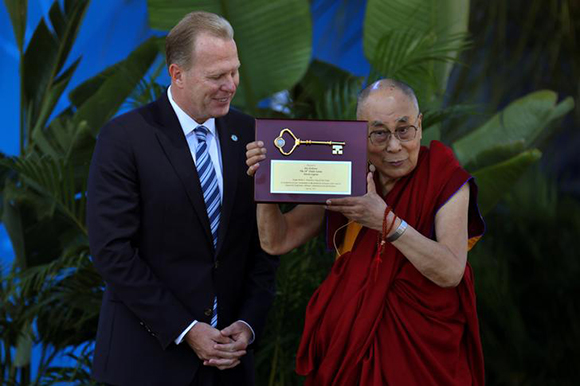 The Dalai Lama receives a key to the city from San Diego Mayor Kevin Faulconer before speaking to thousands at the UC San Diego campus in San Diego, California, U.S. June 16, 2017. REUTERS/ Mike Blake