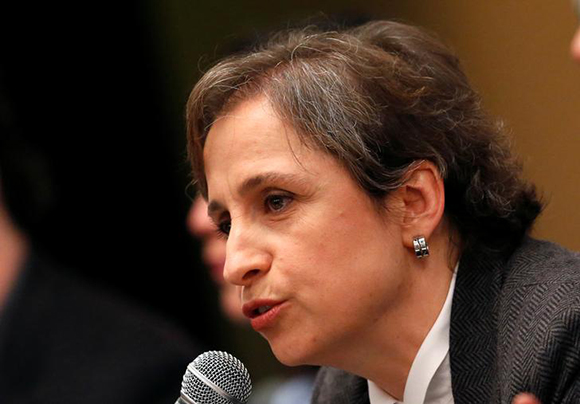 Mexican journalist Carmen Aristegui speaks beside activists, human-rights lawyers and journalists during a news conference in Mexico City, Mexico June 19, 2017. REUTERS/Henry Romero