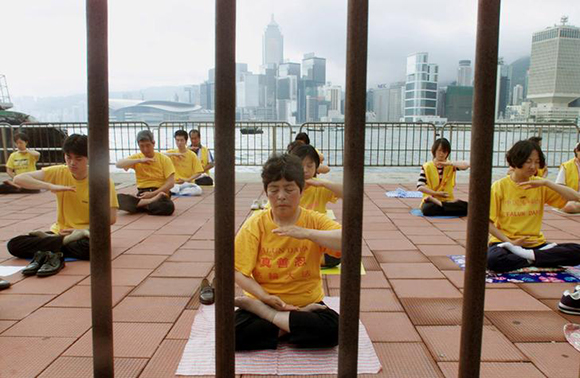 Falun Gong followers meditate in Hong Kong, May 9, 2001. Members of the spiritual movement have over the years protested in Hong Kong after Beijing banned the group on the mainland in 1999, declaring it a "cult". While largely tolerated in Hong Kong, 16 members were convicted in 2002 for protesting outside Beijing's liaison office in the territory. Eight of those convictions were later overturned by Hong Kong's highest court. REUTERS/Kin Cheung/File photo SEARCH "HONGKONG TIMELINE" FOR THIS STORY. SEARCH "WIDER IMAGE" FOR ALL STORIES.