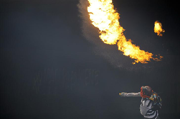 A demonstrator throws a molotov cocktail during a rally against Venezuela's President Nicolas Maduro in Caracas, Venezuela, May 27, 2017. REUTERS/Carlos Barria TPX IMAGES OF THE DAY