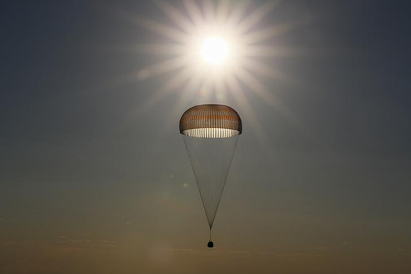 The Soyuz MS-03 capsule carrying the International Space Station (ISS) crew of Oleg Novitskiy of Russia and Thomas Pesquet of France is silhouetted against the sun as it descends beneath a parachute just before landing in a remote area outside the town of Dzhezkazgan (Zhezkazgan), Kazakhstan June 2, 2017. REUTERS/Shamil Zhumatov TPX IMAGES OF THE DAY