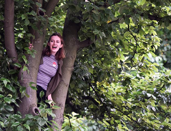 A supporter of Jeremy Corbyn, leader of Britain's opposition Labour Party, waits up a tree for him to arrive at his closing election campaign rally in London, June 7, 2017. REUTERS/Hannah McKay