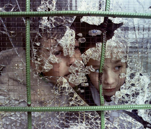 Children peek out of a shattered window in Sarajevo November 21.