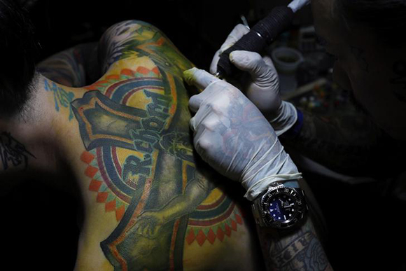 Tattoo artist Endless Sun works on a customer at Taipei International Tattoo & Music Festival in Taipei, Taiwan July 9, 2017. Photo by Tyrone Siu
