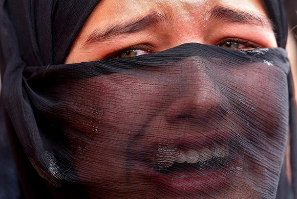 A girl mourns during the funeral of Aaquib Gul, who according to local media, was killed in a gun battle with Indian security forces at the Radbugh Village of Budgam District, in Srinagar July 12, 2017. Photo by Danish Ismail