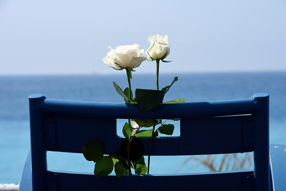  White roses are placed on a chair along the Promenade des Anglais as part of the commemorations of fatal truck attack on the Promenade des Anglais in Nice, France. Photo by Jean-Pierre