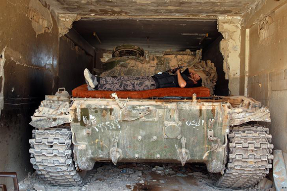  A Free Syrian Army fighter rests on a tank in al-Manshiyeh neighbourhood in Deraa, Syria July 21, 2017. Photo by Alaa Al-Faqir