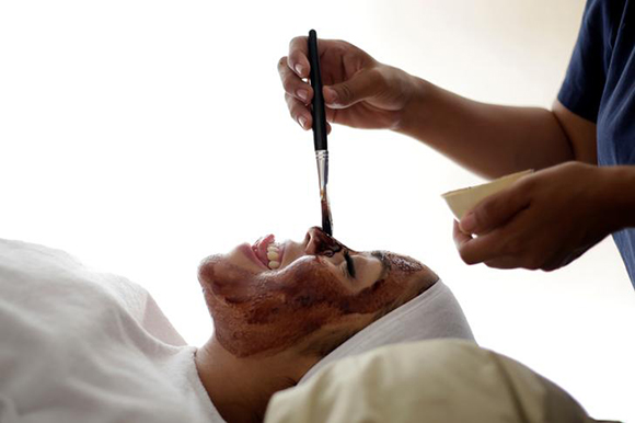  A woman reacts as a beauty therapist applies a face mask made out of chocolate at a natural health and beauty clinic in Ciudad Juarez, Mexico. Photo by Jose Luis Gonzalez 