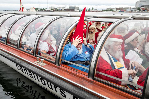  People dressed as Santa Claus take a canal tour of Copenhagen as they take part in the World Santa Claus Congress. Copenhagen, Denmark. Photo by Nikolai Linares 