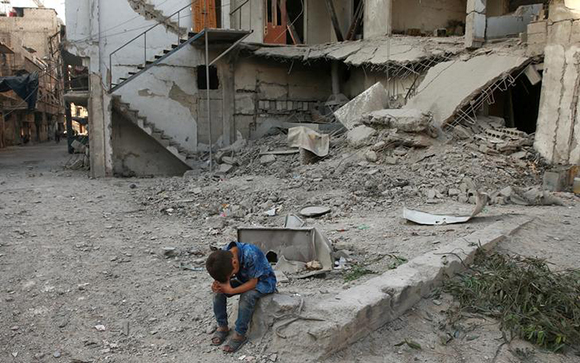  A boy sits near rubble of damaged buildings in Arbin, a town in the Damascus countryside, Syria July 25, 2017. Photo by Bassam Khabieh