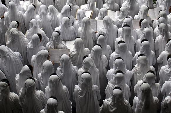  Catholic nuns from the Missionaries of Charity order sing hymns for a special prayer during the eleventh death anniversary of Mother Teresa in the eastern Indian city of Kolkata. Photo by Jayanta Shaw