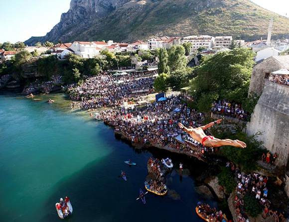 Lorens Listo jumps from the Old Bridge during the 451st traditional diving competition in Mostar, Bosnia and Herzegovina Photo by Dado Ruvic
