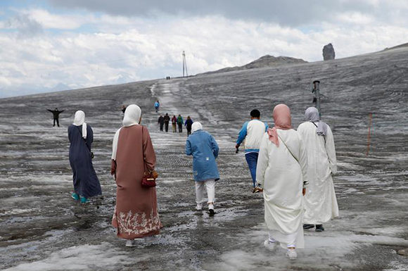 Tourists walk on the Tsanfleuron Glacier at Glacier 3000 in Les Diablerets, Switzerland August 4, 2017. Photo by Denis Balibouse