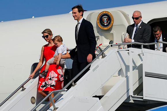 White House senior advisors Ivanka Trump, holding her youngest child Theodore, and Jared Kushner (reflection, C) arrive aboard Air Force One with U.S. President Donald Trump to begin their summer vacation at his Bedminster estate, at Morristown Airport in Morristown, New Jersey, U.S. August 4, 2017. Photo by Jonathan Ernst