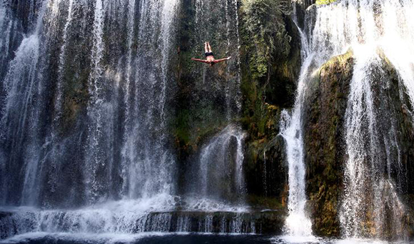 A competitor takes part in the annual international waterfall jumping competition held in the old town of Jajce, Bosnia and Herzegovina. Photo by Dado Ruvic