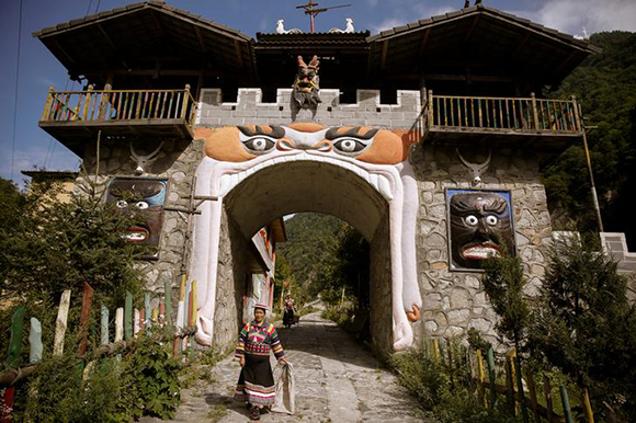 Women in traditional clothes walk in the Tibetan village of Gaoshinao in Jiuzhaigou county, south of the epicentre of Tuesday's earthquake, Sichuan province, China, August 11, 2017. Photo by Thomas Peter