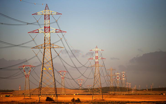 Power lines connecting pylons of high-tension electricity are seen in Montalto Di Castro, Italy, August 11, 2017. Photo by Max Rossi