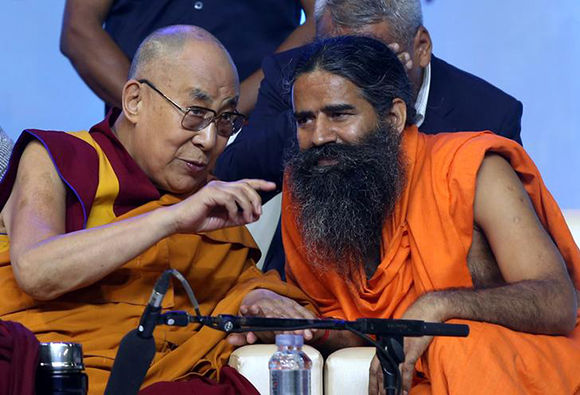 Tibetan spiritual leader the Dalai Lama and Yoga Guru Baba Ramdev interact during the World Peace and Harmony conclave ahead of India's Independence Day in Mumbai, India August 13, 2017. Photo by Shailesh Andrade