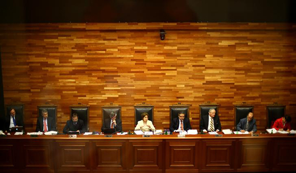 Members of the Constitutional Tribunal are seen through a glass as they discuss the legality of a bill that would allow for abortions in certain cases, in Santiago, Chile August 18, 2017. Photo by Ivan Alvarado