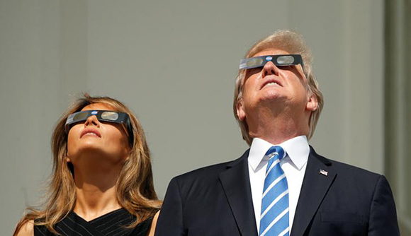 U.S. President Donald Trump and Melania Trump watch the solar eclipse from the White House in Washington, U.S., August 21, 2017. Photo by Kevin Lamarque